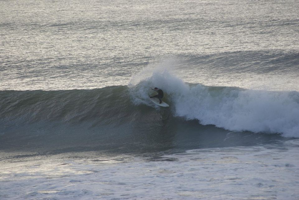 Kevin driving through a turn under the lip on a grey morning