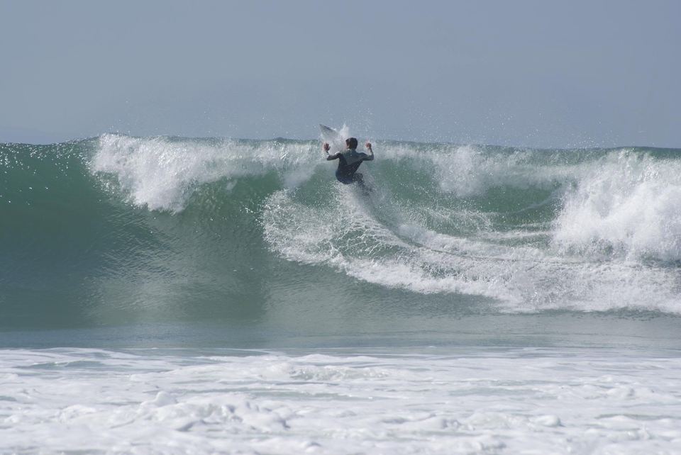 Kevin hitting the lip of a breaking wave